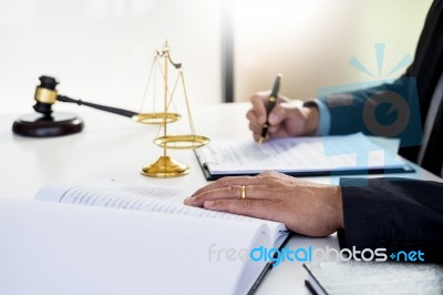 Lawyer Judge Reading Writes The Document In Court At His Desk Stock Photo