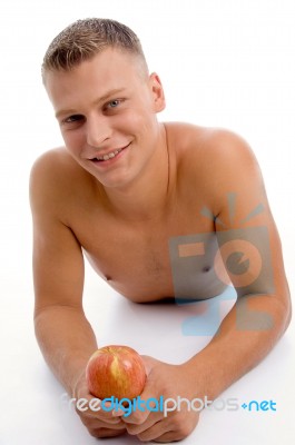 Laying Fit Guy With Apple Stock Photo