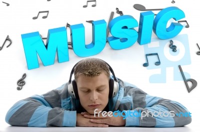 Laying Man Enjoying Music Stock Photo