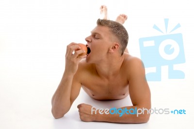 Laying Man Going To Eat Apple Stock Photo