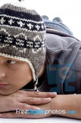 Laying Man Wearing Woollen Cap Stock Photo