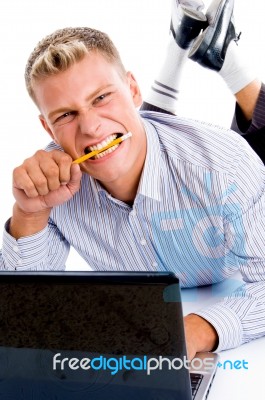 Laying Man With Notebook And Looking At Camera Stock Photo