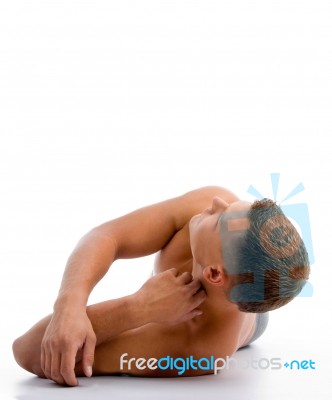 Laying Muscular Man Looking Upward Stock Photo