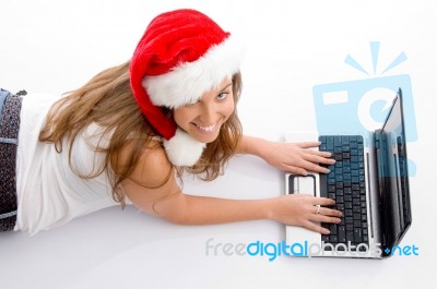 Laying Young Female With Christmas Hat And Laptop Stock Photo