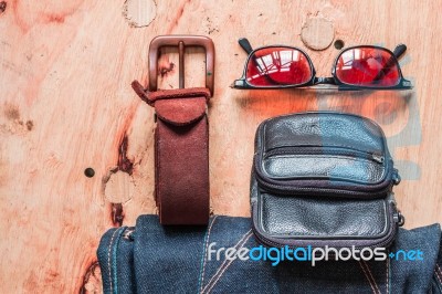 Leather And Jeans On A Wooden Stock Photo