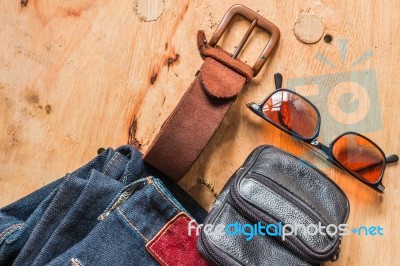 Leather And Jeans On Wooden Stock Photo