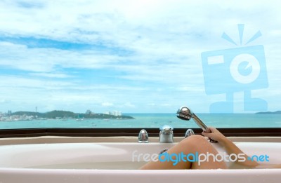 Leg In Bathtub On Sea View Background Stock Photo