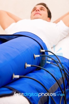 Legs Pressotherapy Machine On Man In Beauty Center Stock Photo