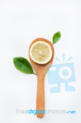 Lemon Slices On Wooden Spoon With Leaf Isolated Stock Photo