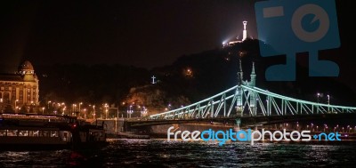 Liberty Bridge And Statue Illuminated At Night In Budapest Stock Photo