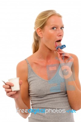 Licking Yogurt Pot Lid Stock Photo