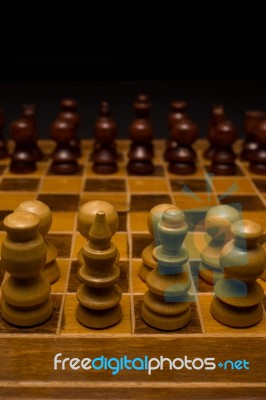 Light And Dark Wooden Chess Pieces On Chess Table Stock Photo