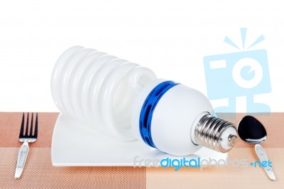 Light Bulb On Dish Isolated Stock Photo