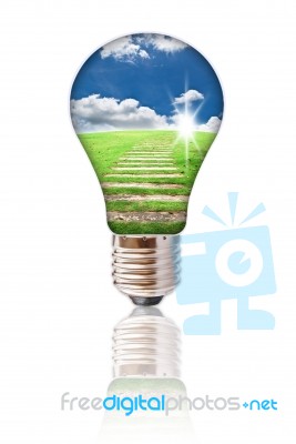 Light Bulb With Blue Sky And Grass Stock Photo