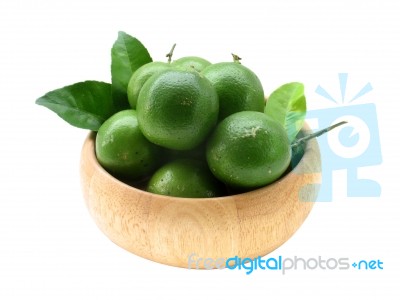 Lime And Leaf In Wood Bowl With Isolate White Background Stock Photo