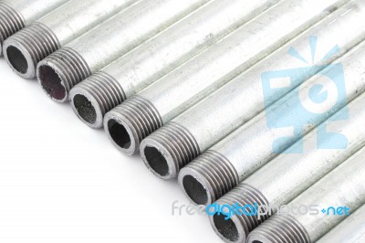 Line Of Iron Water Pipe With Strand On White Floor Stock Photo