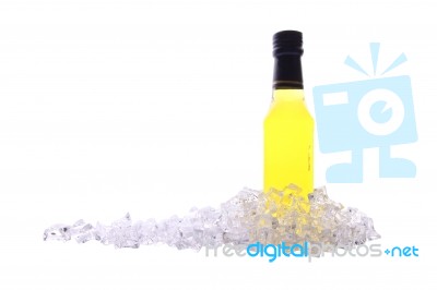 Liquor Bottle And Ice Cracked On White Background Stock Photo