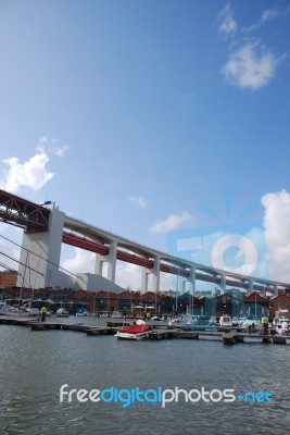 Lisbon's Docks Under April 25th Bridge Stock Photo