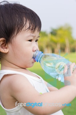 Little Asian Girl  Drinking Water From Plastic Bottle Stock Photo