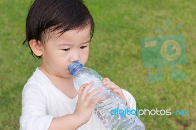 Little Asian Girl  Drinking Water From Plastic Bottle Stock Photo