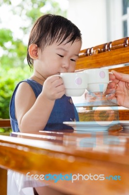 Little Asian Girl (thai)  Holding A Cup Stock Photo