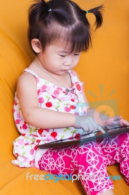 Little Asian Girl Using Digital Tablet, Child Finger Point At Co… Stock Photo