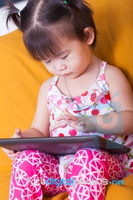 Little Asian Girl Using Digital Tablet, Child Finger Point At Co… Stock Photo