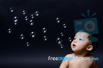 Little Baby Asian Boy Looking Soap Bubbles Stock Photo