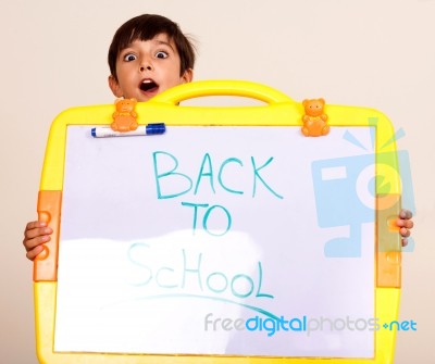 Little Boy Holding A Whitebaord Stock Photo