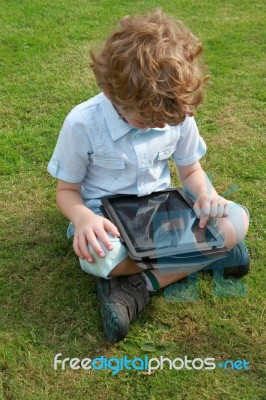 Little Boy On Ipad Stock Photo