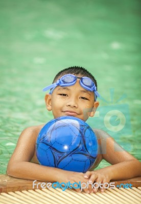 Little Boy Playing In Swimming Pool Stock Photo