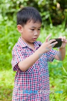 Little Boy Taking Photos By Digital Camera On Smartphone With Go… Stock Photo