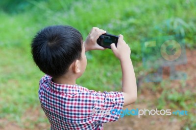 Little Boy Taking Photos By Digital Camera On Smartphone With Go… Stock Photo