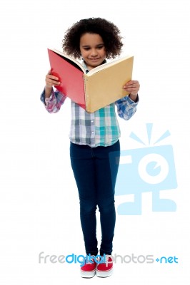 Little Girl A Reading Book Stock Photo