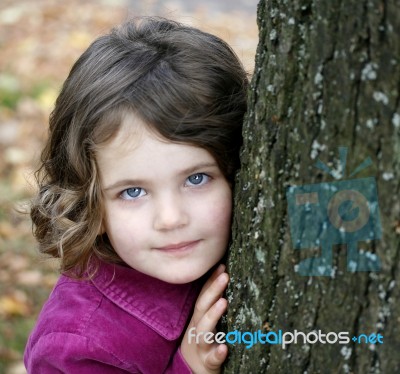 Little Girl By Tree Stock Photo