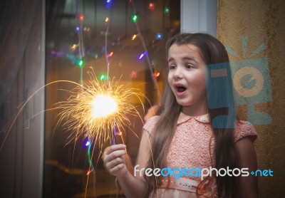 Little Girl Holding A Sparkler Stock Photo