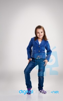 Little Girl In Blue Jeans And Jacket Posing In The Studio Stock Photo