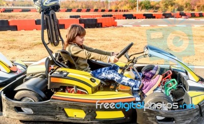 Little Girl Is Driving Go- Kart Car In A Playground Racing Track… Stock Photo