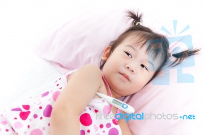 Little Girl Lying On Sickbed With Digital Thermometer In Her Armpit Stock Photo