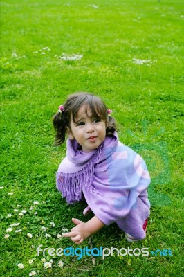 Little Girl Playing On Green Grass Stock Photo