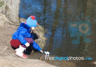 Little Girl Playing With Paper Boat Stock Photo