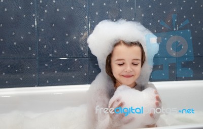 Little Girl Playing With Soap Suds  In A Bath Stock Photo