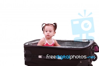 Little Girl Sitting In Suitcase Stock Photo