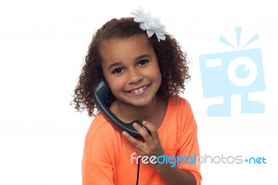 Little Girl Speaking Over Phone Stock Photo