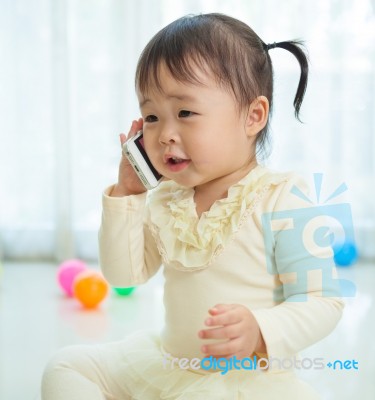 Little Girl Talking On Mobile Phone Stock Photo