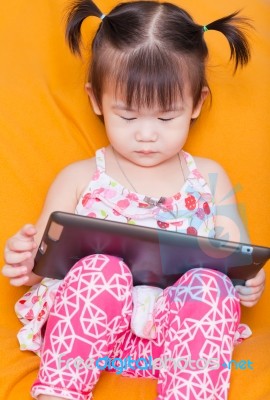 Little Girl Using A Tablet Stock Photo