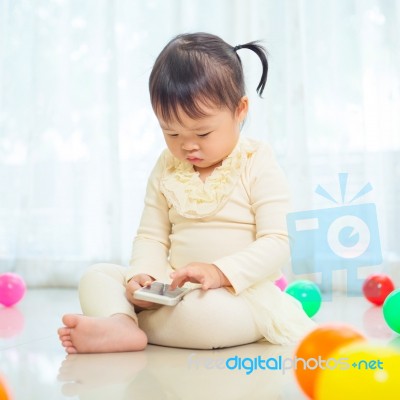 Little Girl Using Mobile Phone Stock Photo