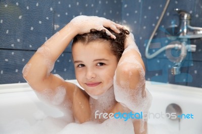 Little Girl Washes Her Head In The Bath Stock Photo