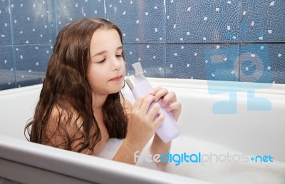 Little Girl Washing Her Hair With Shampoo Stock Photo