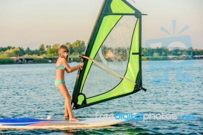 Little Girl Winsurfing On Ada Bojana, Montenegro Stock Photo